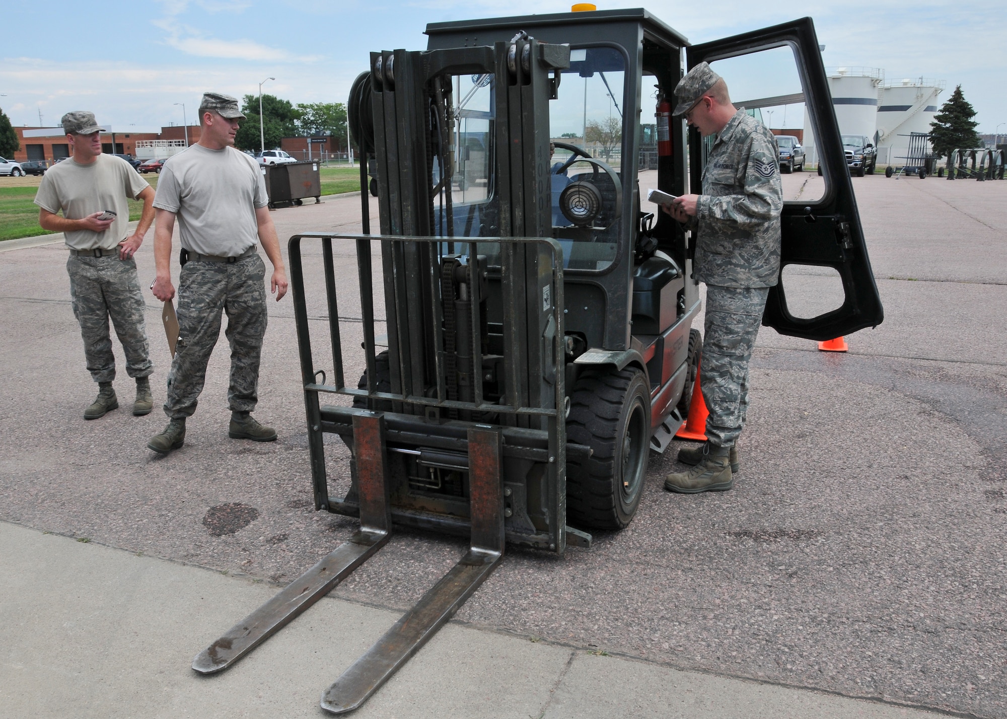 Tech. Sgt. Kyle Sorenson, 114th Logistics Readiness Squadron mobility specialist, performs pre-use inspection procedures as he participates in LRS's forklift rodeo at Joe Foss Field, S.D, on Aug. 2, 2014. The rodeo tested the participant’s communication and driving skills as they navigated machinery holding a full bucket of water through an obstacle course while attempting to lose the minimum amount of water in transit. (National Guard photo by Staff Sgt. Luke Olson/Released)