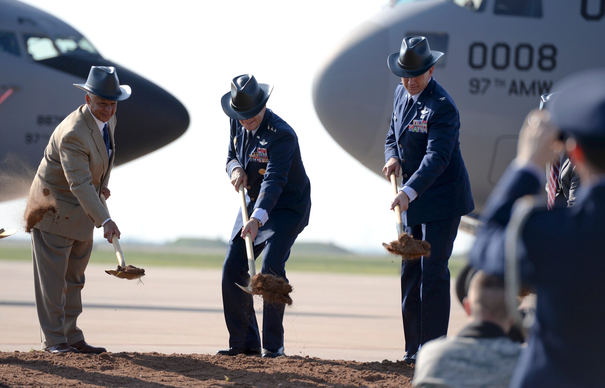 ALTUS AIR FORCE BASE, Okla. – Oklahoma State Representative Charles Ortega, the commander of Air Education and Training Command Gen. Robin Rand and 97th Air Mobility Wing Commander Col. Bill Spangenthal break ground for new KC-46 Pegasus construction projects during a ceremony Aug. 7, 2014. In Southwest Oklahoma fashion, the group wore cowboy construction hats for the dig. Rand attended the event during his visit to meet Airmen and families of the 97th. This is his first visit to Altus AFB since taking command. (U.S. Air Force photo by Staff Sgt. Nathanael Callon/Released) 