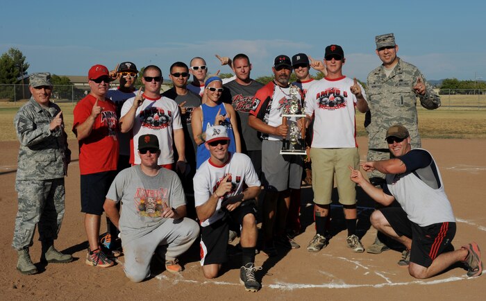 The 9th Munitions Squadron softball team poses for a photo at the conclusion of the 2014 Intramural Softball Championships at O’Malley Field on Beale Air Force Base, Calif., July 31, 2014. 9th MUNS defeated 13th Intelligence Squadron, 19-4. (U.S. Air Force photo by Staff Sgt. Robert M. Trujillo/Released)