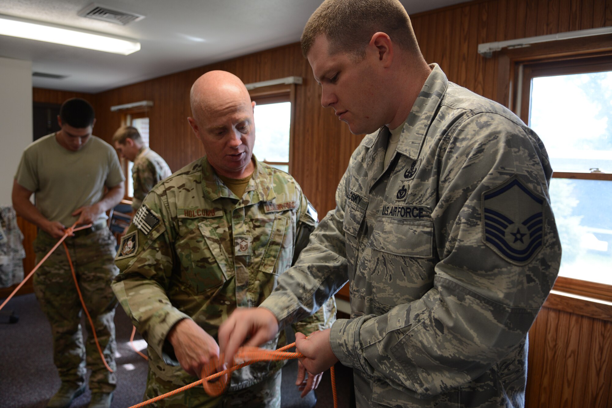 Master Sgt. Gilbert E. Holcomb, 115th Fighter Wing explosive ordnance disposal flight resources non-commissioned officer in-charge, teaches EOD Airmen how to tie proper knots during the 2014 PATRIOT exercise at Volk Field Air National Guard Base, Wis., July 20, 2014. The team later used their knot-tying skills to safely lower themselves down a three-story building. (Air National Guard photo by Senior Airman Andrea F. Liechti)