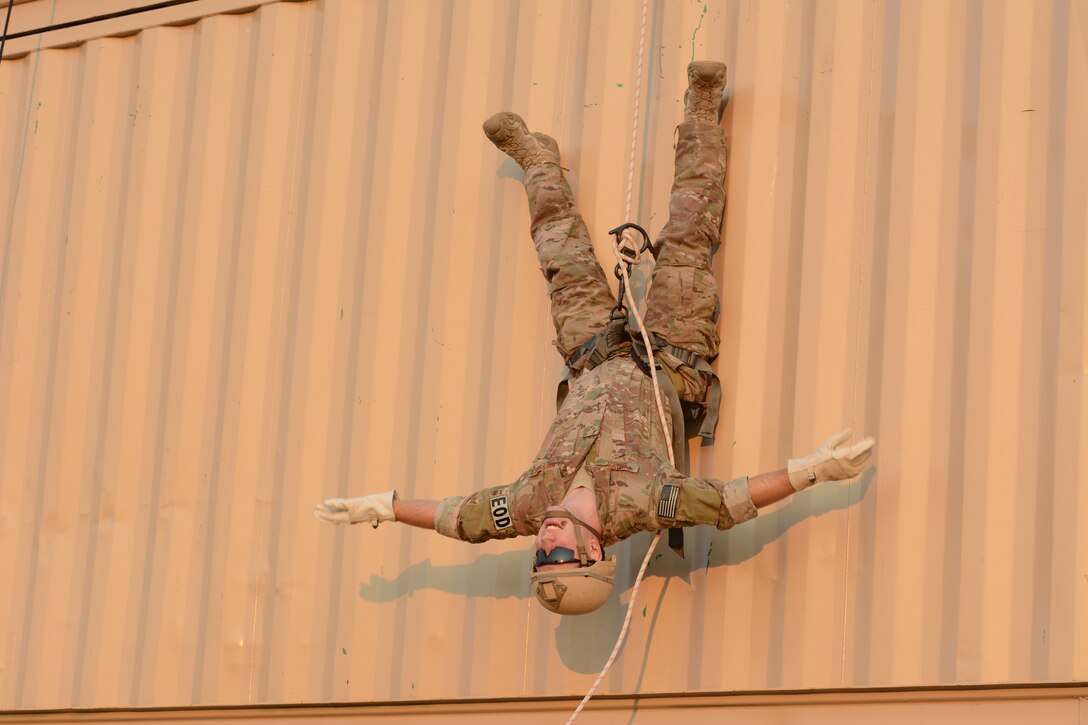 Senior Airman Nash Bauer, 115th Fighter Wing explosive ordnance disposal flight, hangs upside down while rappelling during the 2014 PATRIOT exercise at Volk Field Air National Guard Base, Wis., July 20, 2014. The EOD Airmen in attendance to the exercise learned how to tie proper knots for rappelling, participated in fast rope exercises, climbed a free-falling ladder, assembled and disassembled various bomb types, and received all-terrain vehicle training certification during their stay. (Air National Guard photo by Senior Airman Andrea F. Liechti)