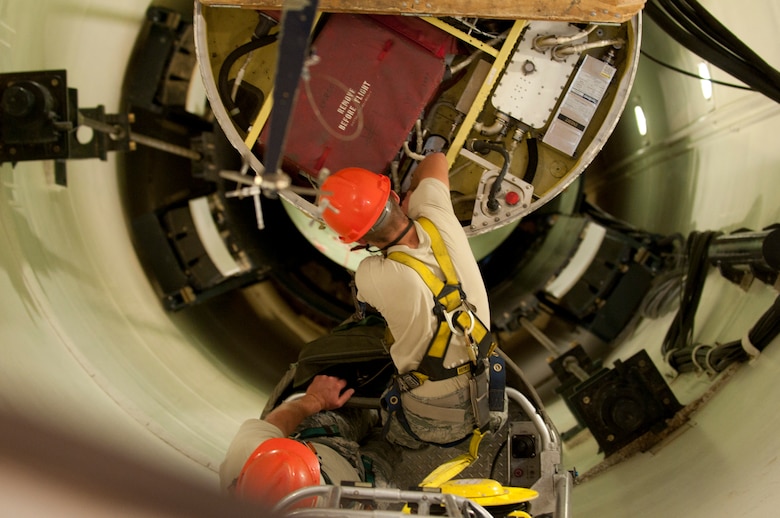 Airman 1st Class Leslie Friestad, 90th Maintenance Operations Squadron, performs maintenance on a missile guidance set during missile maintenance training in the U-01 practice launch facility on F.E. Warren Air Force Base, Aug. 4, 2014. The practice launch facility prepares Airmen for the rigorous maintenance they will have to routinely conduct on actual missiles as part of their duties. (U.S. Air Force photo by Lan Kim)