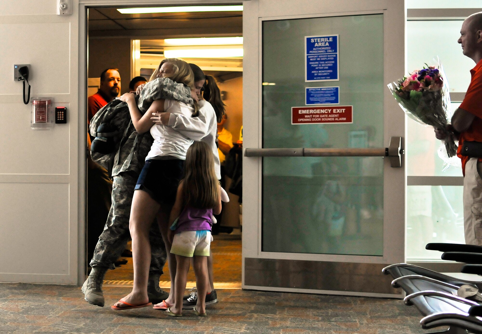 U.S. Air Force Tech. Sgt. Stacy A. Merdian, security forces craftsman with the 182nd Security Forces Squadron, reunites with family and friends after arriving home at the General Wayne A. Downing Peoria International Airport in Peoria, Ill., Aug. 6, 2014. She and 17 Illinois Air National Guardsmen deployed to Southwest Asia for seven months in support of Operation Enduring Freedom. They were assigned to the 405th Expeditionary Security Forces Squadron overseas, where they were responsible for law enforcement and security missions in the region’s global war on terror. (U.S. Air National Guard photo by Staff Sgt. Lealan Buehrer/Released)