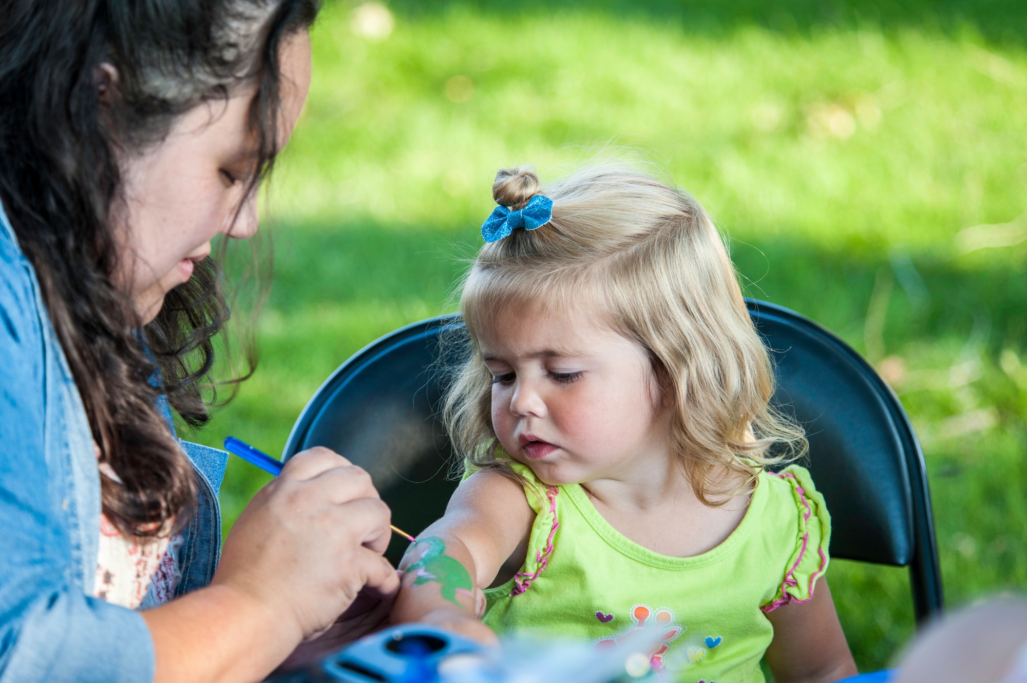 Fairchild children were able to get washable tattoos during the installation’s National Night Out celebration at Fairchild Air Force Base, Washington, Aug. 5, 2014. The event is held across the country to help prevent crime and drugs from entering “our” neighborhoods. (U.S. Air Force photo by Staff Sgt. Benjamin W. Stratton/Released)