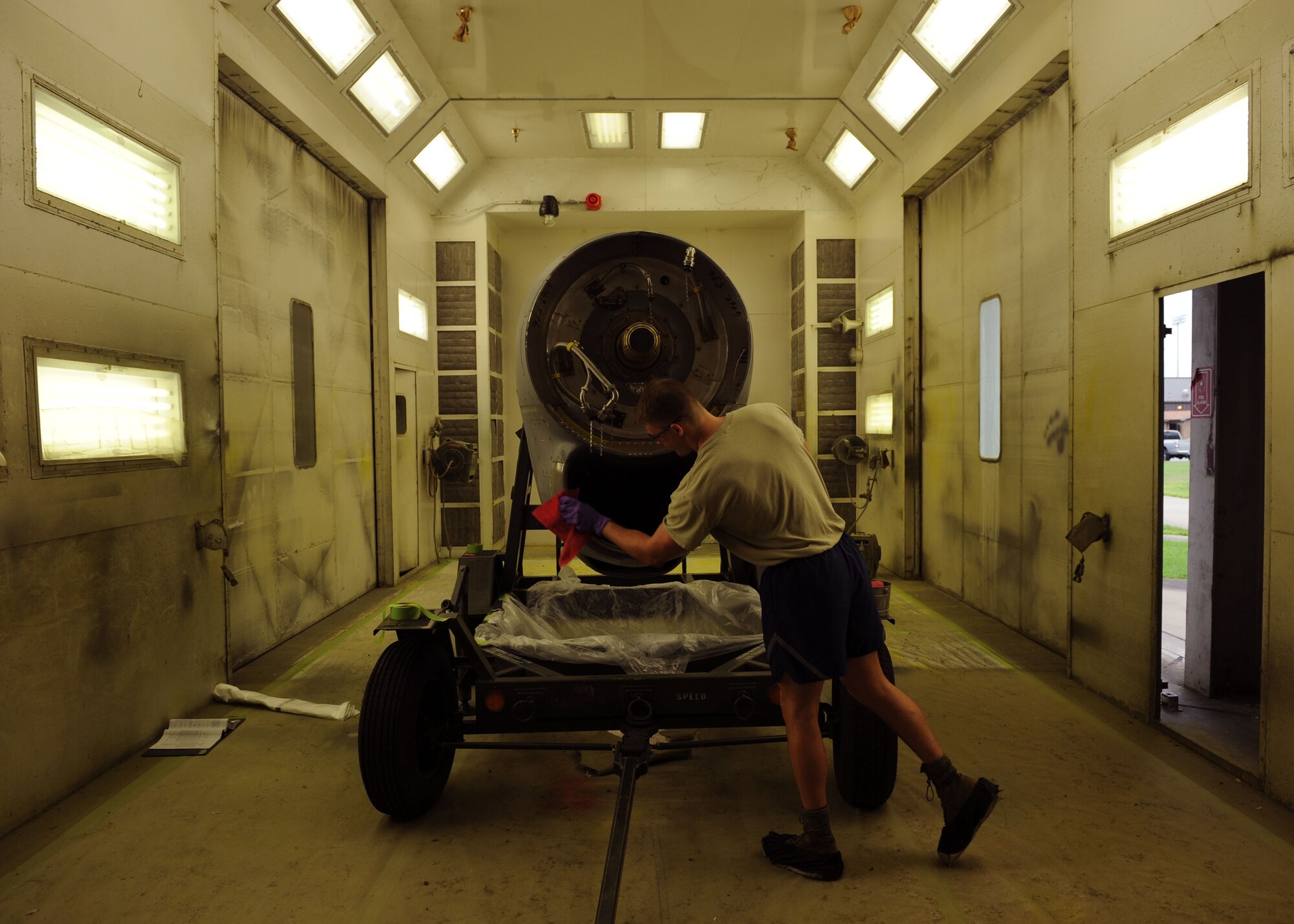 Senior Airman Charles Clark, a 19th Maintenance Squadron structural maintenance journeyman, wipes off certain areas of a C-130 engine so masking tape will adhere July 17, 2014, at Little Rock Air Force Base, Ark. Masking tape, paper and plastic are used to prevent areas from being painted and keep dust and debris out of the engine. (U.S. Air Force photo by Airman 1st Class Scott Poe)