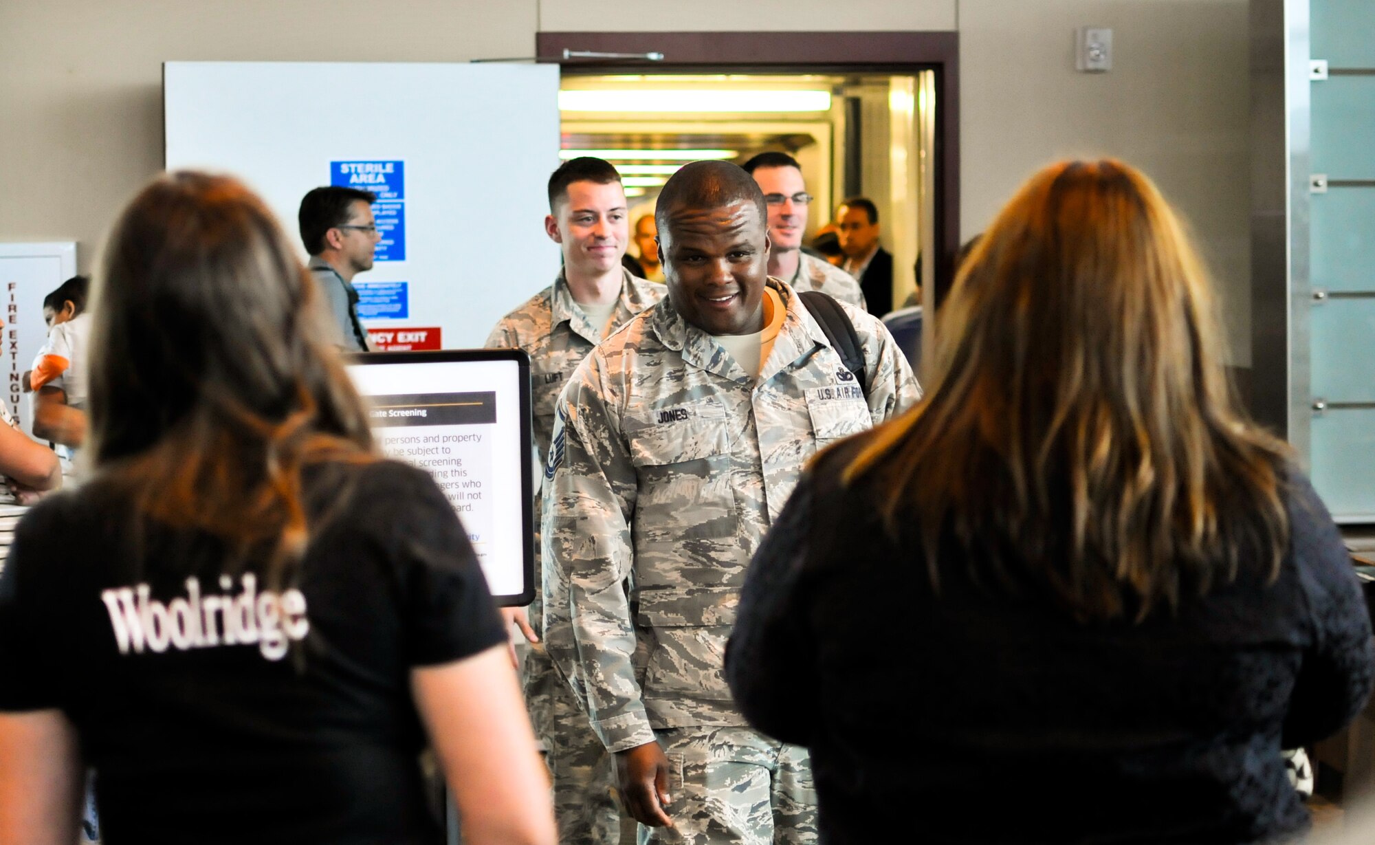 U.S. Air Force Master Sgt. Christopher R. Jones, squad leader with the 182nd Security Forces Squadron, leads the way as his Airmen arrive home at the General Wayne A. Downing Peoria International Airport in Peoria, Ill., Aug. 6, 2014. He and 17 Illinois Air National Guardsmen deployed to Southwest Asia for seven months in support of Operation Enduring Freedom. They were assigned to the 405th Expeditionary Security Forces Squadron overseas, where they were responsible for law enforcement and security missions in the region’s global war on terror. (U.S. Air National Guard photo by Staff Sgt. Lealan Buehrer/Released)