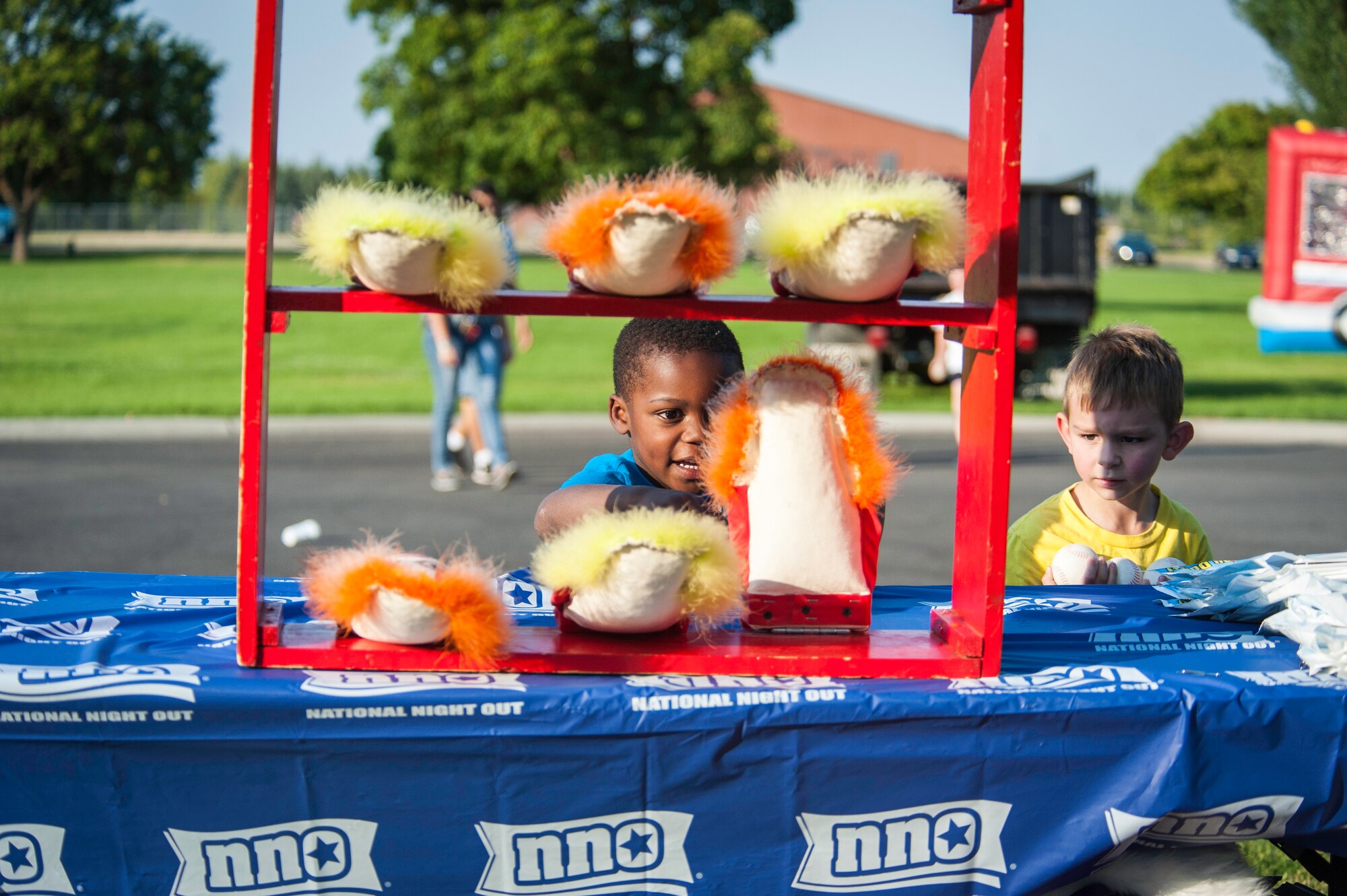 Fairchild children play games during the installation’s National Night Out celebration at Fairchild Air Force Base, Washington, Aug. 5, 2014. The event is held across the country to help prevent crime and drugs from entering “our” neighborhoods. (U.S. Air Force photo by Staff Sgt. Benjamin W. Stratton/Released)