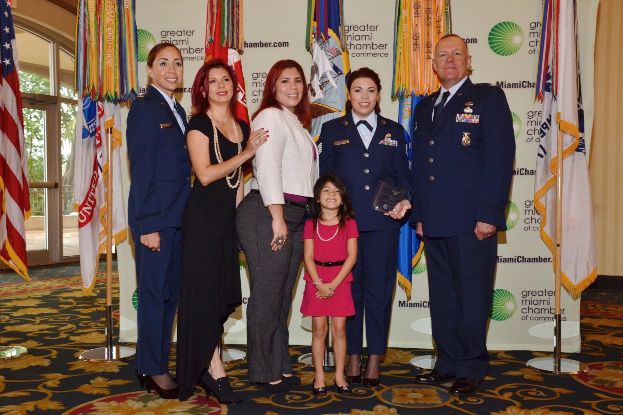 Tech. Sgt. Eleanor Bravo, 482nd Mission Support Group, stands with her family and her leadership at Military Service Person of the Year Award trustee luncheon. Bravo was awarded based on her military service and community involvement. (Courtesy photo)