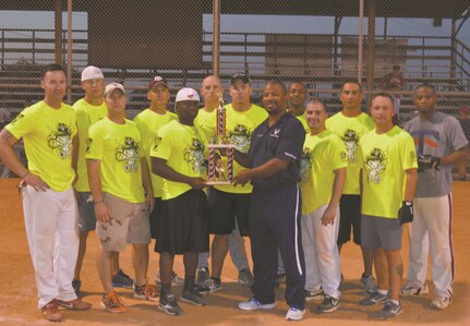 Joint Base San Antonio-Lackland Fitness and Sports Director Dwayne Reed presents the 737th Training Group with the JBSA-Lackland Intramural Softball trophy Aug. 6, 2014 at Warhawk Field  (Photo by Jose T. Garza III).