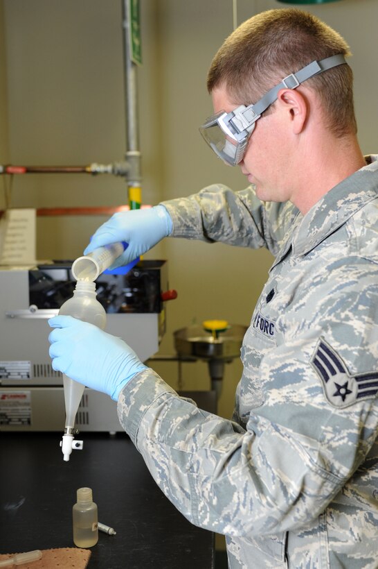 Senior Airman Derek Brannan, 28th Logistics Readiness Squadron fuels laboratory technician, performs a fuel system icing inhibitor concentration test at Ellsworth Air Force Base, S.D., July 30, 2014. The reading from the test determines the concentration of FSII in the fuel, which prevents the water in the fuel, present due to atmospheric moisture evaporating and condensing inside pipes, tanks and trucks and acceptable at 10 parts per million, from freezing when planes reach high altitudes.   (U.S. Air Force photo by Senior Airman Hailey R. Staker/Released)   
