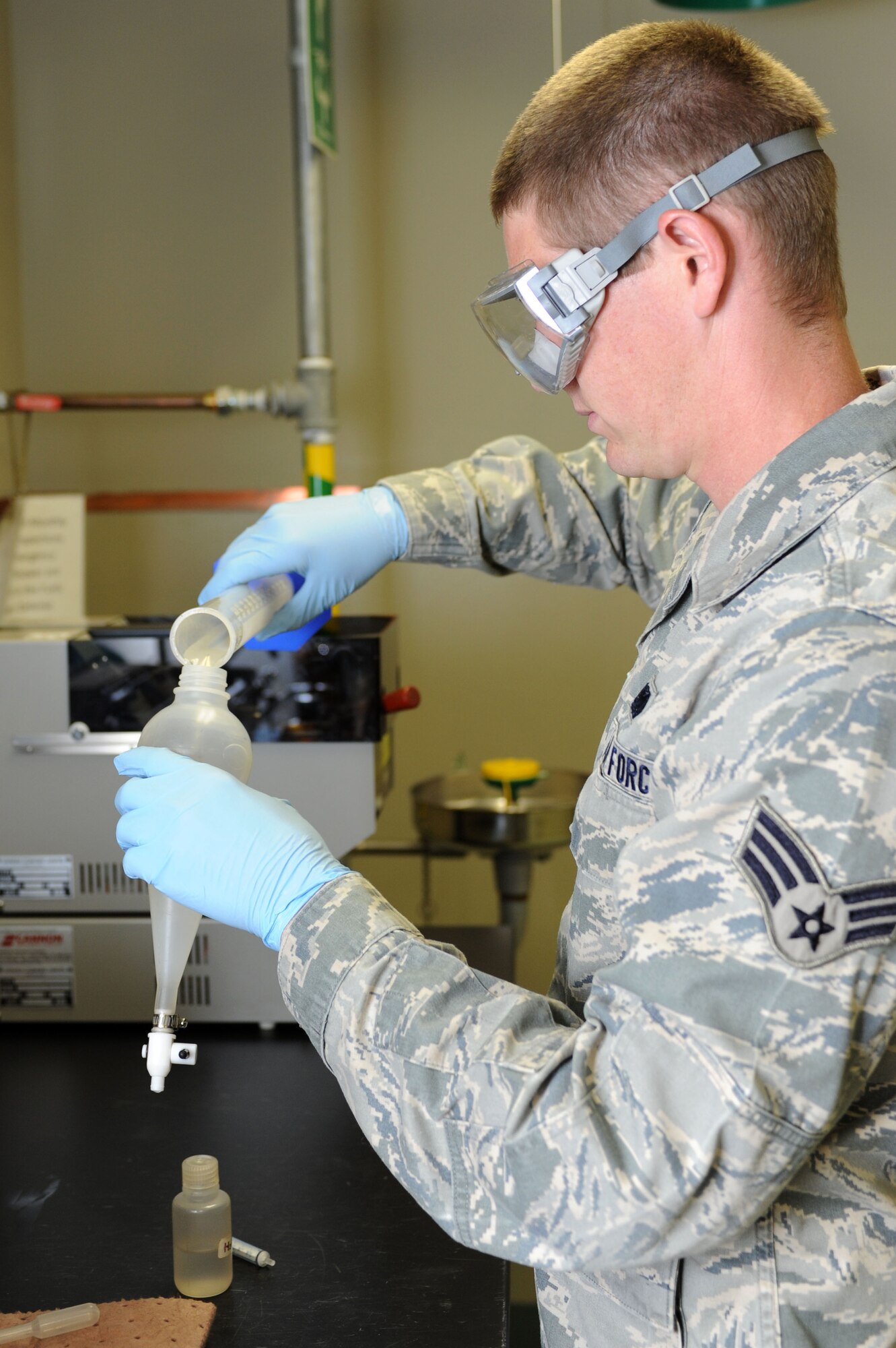 Senior Airman Derek Brannan, 28th Logistics Readiness Squadron fuels laboratory technician, performs a fuel system icing inhibitor concentration test at Ellsworth Air Force Base, S.D., July 30, 2014. The reading from the test determines the concentration of FSII in the fuel, which prevents the water in the fuel, present due to atmospheric moisture evaporating and condensing inside pipes, tanks and trucks and acceptable at 10 parts per million, from freezing when planes reach high altitudes.   (U.S. Air Force photo by Senior Airman Hailey R. Staker/Released)   