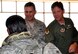 302nd Airlift Wing Commander Col Courtney Arnold (right) and 302nd Mission Support Commander Marty Hughes welcome home the returning 302nd Security Forces Airmen here June 16, 2014.
Three Airmen assigned to the 302nd Security Forces Squadron returned to Colorado Springs, Colorado after a 120-day deployment to the Transit Center at Manas, Kyrgyzstan. The Airmen provided for the location’s integrated base defense, physical security and antiterrorism and force protection measures and aided in the closure and inactivation of the transit center. These reservists were among the last of the approximately 20 security forces recently deployed to return home.  (U.S. Air Force photo/Ann Skarban)
