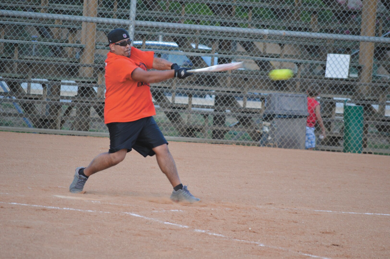 Defense Information Systems Agency first baseman Christopher Quintero, defense connect online tier 3 systems engineer, takes a swing in the fifth inning of the agency's matchup against the 453rd Electronic Warfare Squadron July 21 (U.S. afir Force Photo by Jose T. Garza III).