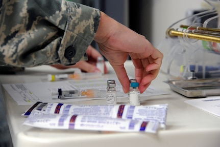 Senior Airman Kelly Boos prepares to administer multiple vaccinations to a patient Aug. 6, 2014, at the Joint Base San Antonio-Randolph Immunizations Clinic. Boos is an aerospace medical technician. (U.S. Air Force photo/Desiree N. Palacios)