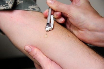 Senior Airman Kelly Boos, right, administers a tuberculosis test vaccination to 2nd Lt. Ryan Yochum, left, Aug. 6, 2014, at the Joint Base San Antonio-Randolph Immunizations Clinic. Boos is an aerospace medical technician and Yochum is a student with the 588th Flying Training Squadron. (U.S. Air Force photo/Desiree N. Palacios)