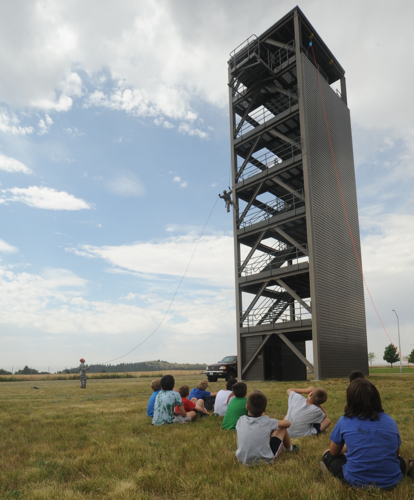 An Airman from the 336th Training Group rappels down a simulated skyscraper at Fairchild Air Force Base, Washington, Aug. 1, 2014. The action was part of a demonstration for children that comprised a tour group from the Northeast Youth Center of Spokane summer camp so they could experience military missions. (U.S. Air Force photo by Airman 1st Class Sam Fogleman/Released)