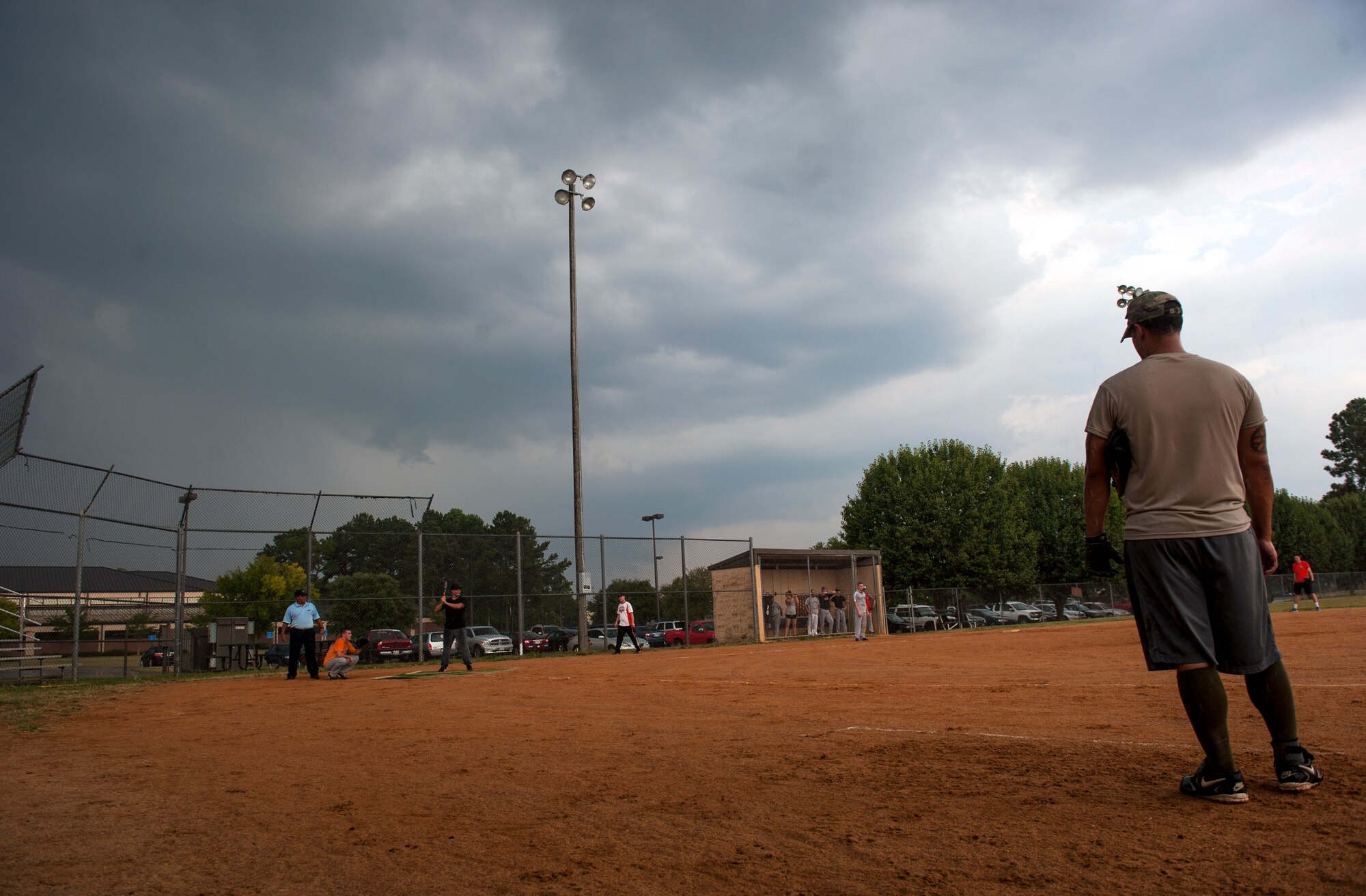 A player from the 723d Aircraft Maintenance Squadron watches as his team goes up to bat at Moody Air Force Base, Ga., Aug. 6, 2014. Part way through the game it began to rain, eventually forcing the teams to reschedule for the next day. (U.S. Air Force photo by Senior Airman Jarrod Grammel/Released)
