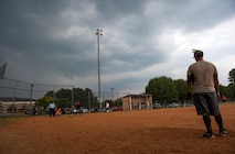A player from the 723d Aircraft Maintenance Squadron watches as his team goes up to bat at Moody Air Force Base, Ga., Aug. 6, 2014. Part way through the game it began to rain, eventually forcing the teams to reschedule for the next day. (U.S. Air Force photo by Senior Airman Jarrod Grammel/Released)
