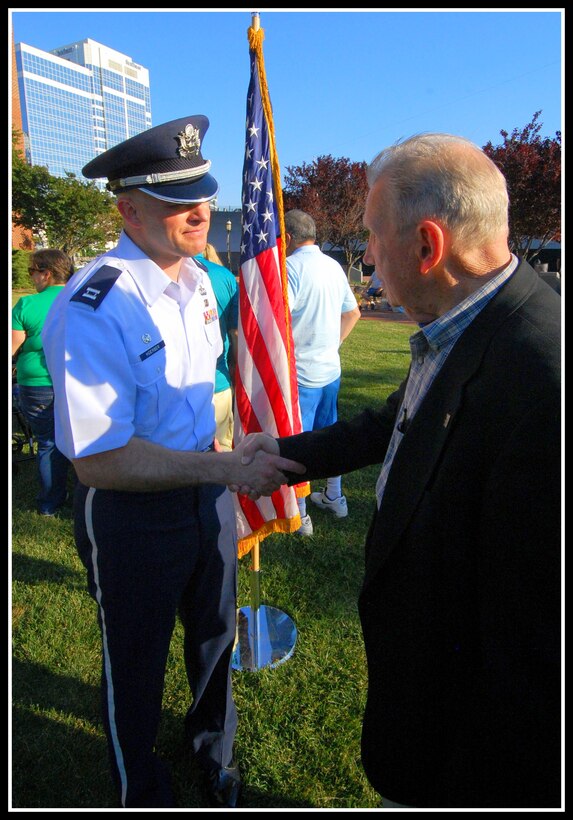 Captain Michael Hoerber, Commander of the USAF Heritage of America Band, greets Col Ed Shames, a decorated veteran of World War II and one of the original members of the "Band of Brothers."  The Heritage of America Band presented a special tribute to the 70th anniversary of D-Day, including the narrative story of Col Shames and other WWII veterans in Norfolk, VA on June 7, 2014.