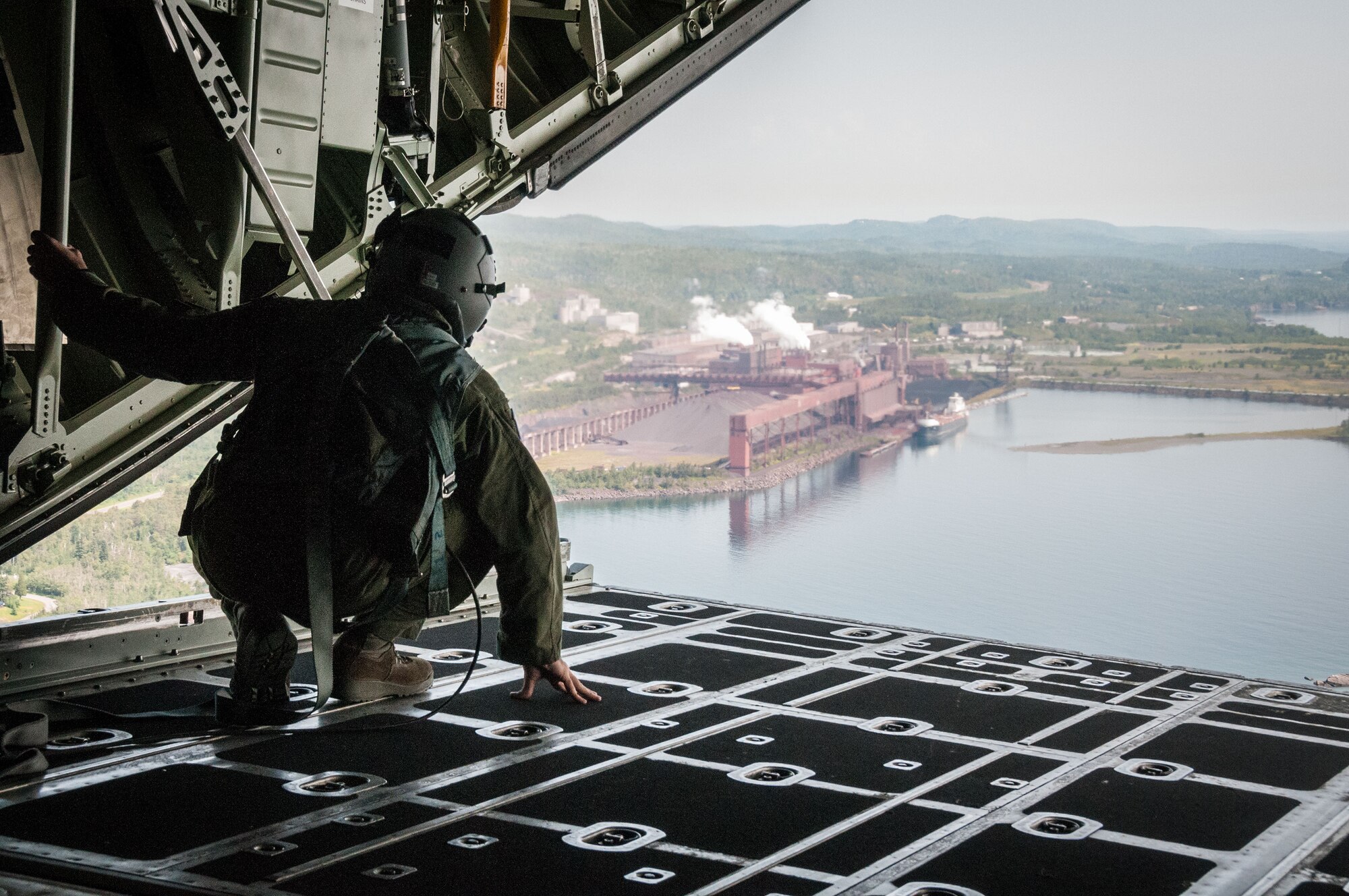 Staff Sgt. Cody Schroeder, 96th Airlift Squadron loadmaster, looks out over Silver Bay, Minn., from a C-130 aircraft during an Employers' Day flight Aug. 2.  The annual event allows employers to see what their employees do during Unit Training Assembly weekends, learn more about the Reserve mission and gain a greater understanding of what it means for their employee(s) to be a member of the 934 AW.  (U.S. Air Force photo/Staff Sgt. Cherish Chavez)