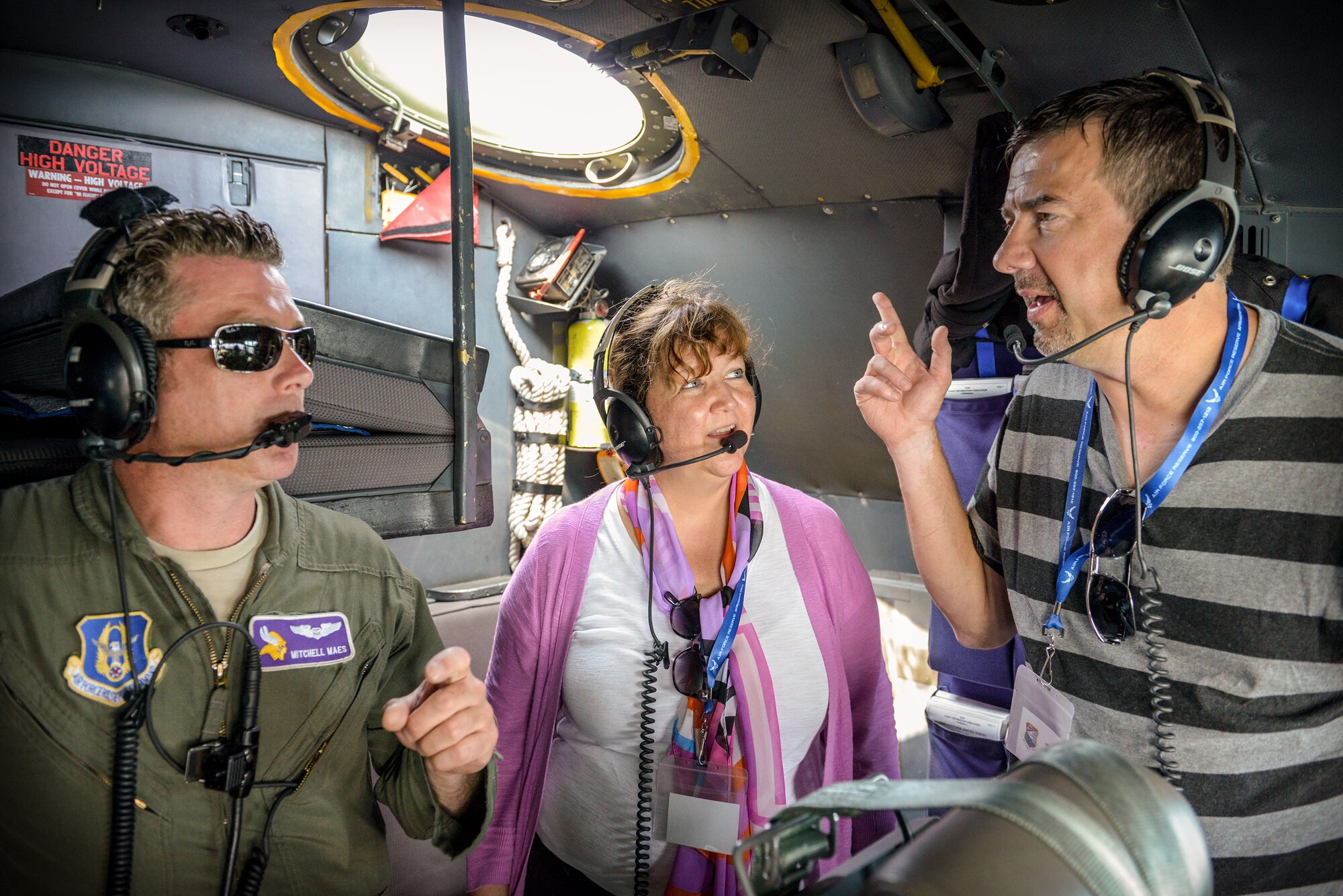 Maj. Mitchell Maes, 934th Operations Support Squadron navigator, answers questions from Julie Stout and Jeff Pederson, civilian employers of 934th Airlift Wing Reservists, aboard a C-130 aircraft during an Employers' Day flight Aug. 2.  The annual event allows employers to see what their employees do during Unit Training Assembly weekends, learn more about the Reserve mission and gain a greater understanding of what it means for their employee(s) to be a member of the 934 AW.  (U.S. Air Force photo/Staff Sgt. Trevor Saylor)