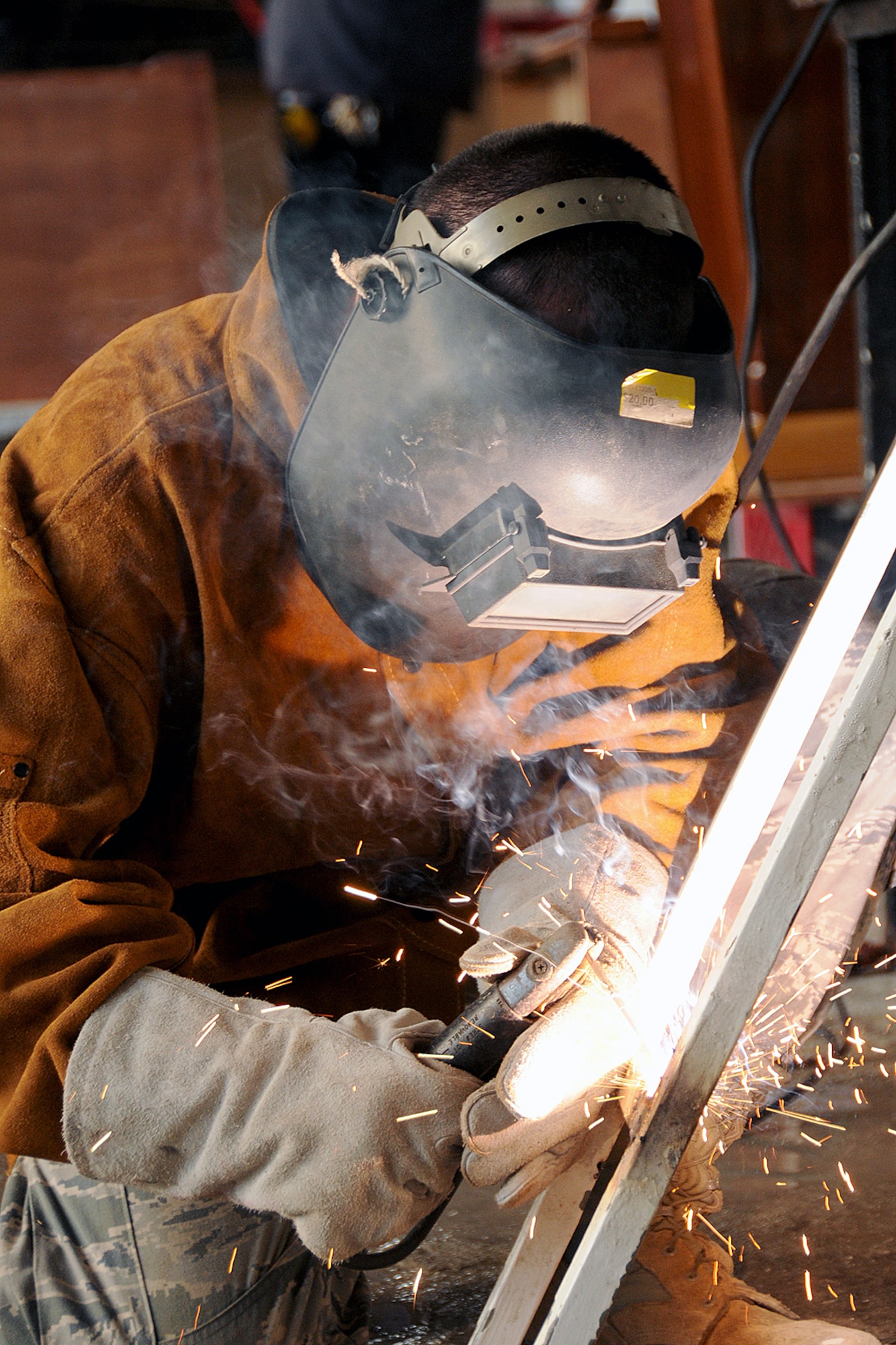 Senior Airman Daniel Douglas Tift, of the Rhode Island Air National Guard,143d Airlift Wing, Civil Engineering Squadron, Structures shop welds steel stairs to cover a high voltage area for the Royal Bahamas Defence Force (RBDF) at the Coral Harbour Base in Nassau, Bahamas on June 19, 2014 for their inaugural group DFT (Deployment For Training) to support the RBDF in conjunction with the National Guard State Partnership Program (SPP). National Guard Photo by Master Sgt John McDonald (RELEASED)
