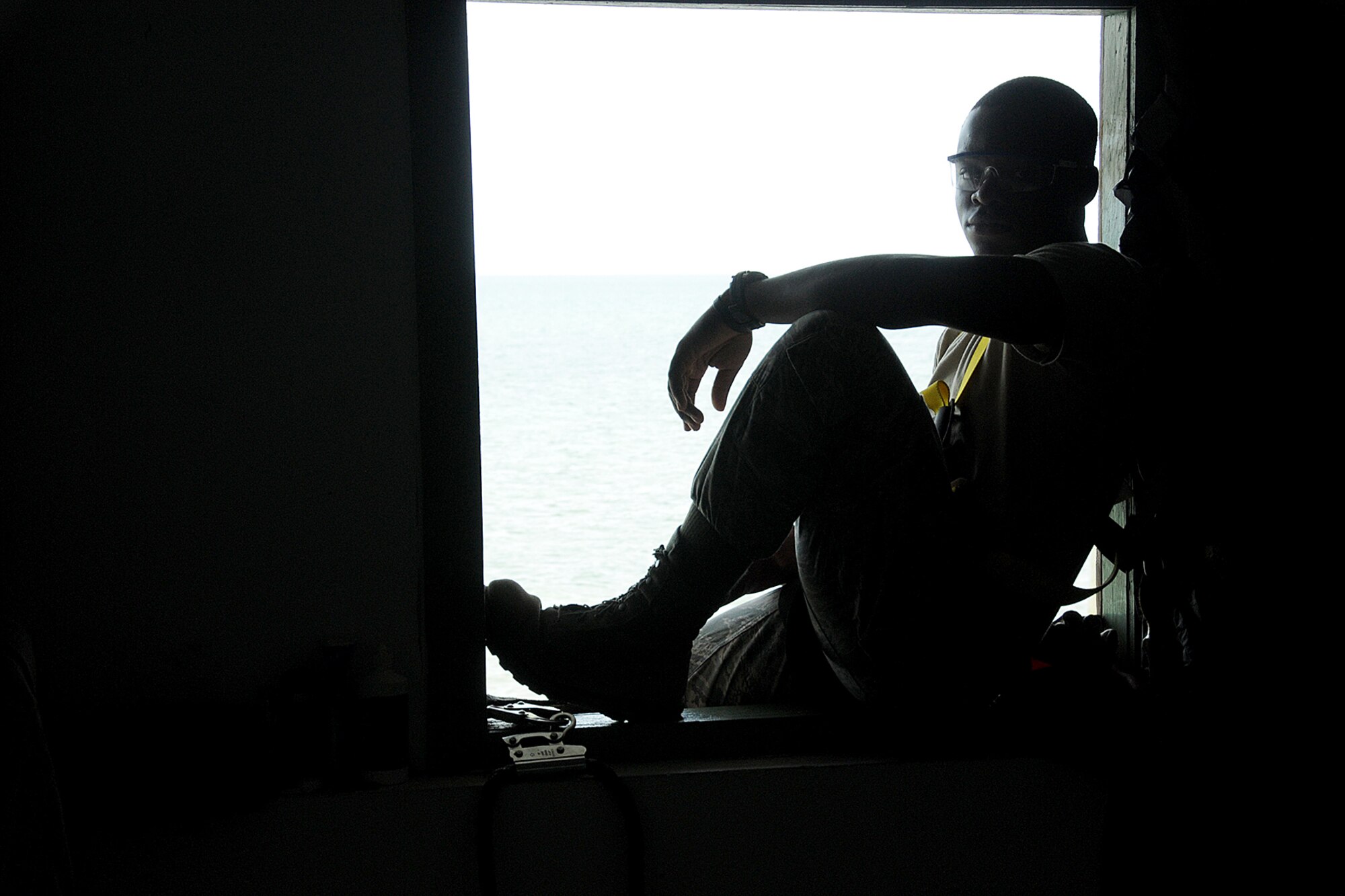 Airman First Class Oluwatomisin Nmn Oyekan of the Rhode Island Air National Guard,143d Airlift Wing, Civil Engineering Squadron, HVAC shop takes a short break after checking the refrigerate pressure for an air conditioning system for the Royal Bahamas Defence Force (RBDF) at the Coral Harbour Base in Nassau, Bahamas on June 19, 2014 for their inaugural group DFT (Deployment For Training) to support the RBDF in conjunction with the National Guard State Partnership Program (SPP). National Guard Photo by Master Sgt John McDonald (RELEASED)