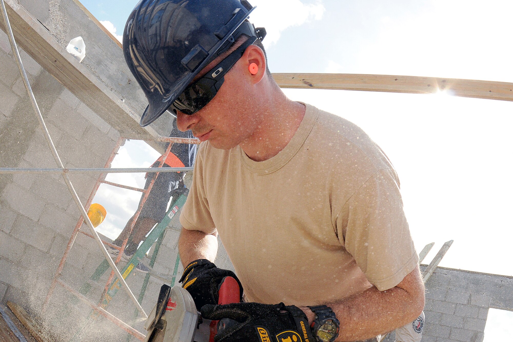 Senior Airman Daniel Douglas Tift, of the Rhode Island Air National Guard,143d Airlift Wing, Civil Engineering Squadron Structures Shop saws joists to a new roof for the women's barracks and latrine for the Royal Bahamas Defence Force (RBDF) at the Coral Harbour Base in Nassau, Bahamas on June 17, 2014 for their inaugural group DFT (Deployment For Training) to support the RBDF in conjunction with the National Guard State Partnership Program (SPP). National Guard Photo by Master Sgt John McDonald (RELEASED)