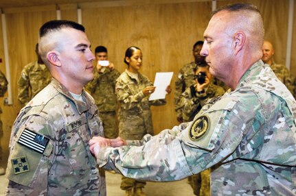 Army Lt. Col. Steven Moon (right) pins the rank of first lieutenant on his son Steve Moon during a promotion ceremony on Kandahar Airfield, Afghanistan, July 14. The elder Moon serves in Regional Command-East as a Ministry of Defense program manager with a Combined Security Transition Command-Afghanistan, Special Operations Planning and Liaison Element in Kabul, Afghanistan, while 1st Lt. Moon is in Regional Command-South in Kandahar serving as a human resources officer for the 704th Brigade Support Battalion, 4th Infantry Bde. Combat Team, 4th Inf. Division. Lt. Col. Moon had business in the area, and was able to highlight his son in the ceremony. Lt. Col. Moon is an Army Reservist who serves as a civilian public affairs specialist at U.S. Army Installation Management Command at Joint Base San Antonio-Fort Sam Houston.
Photo by Army Staff Sgt. Whitney Houston