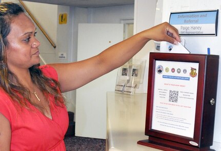 Family member Bernadette West places an issue or suggestion for improvement into an Armed Forces Action Plan box July 30 at the Military & Family Readiness Center at Joint Base San Antonio-Fort Sam Houston.
Photo by Lori Newman