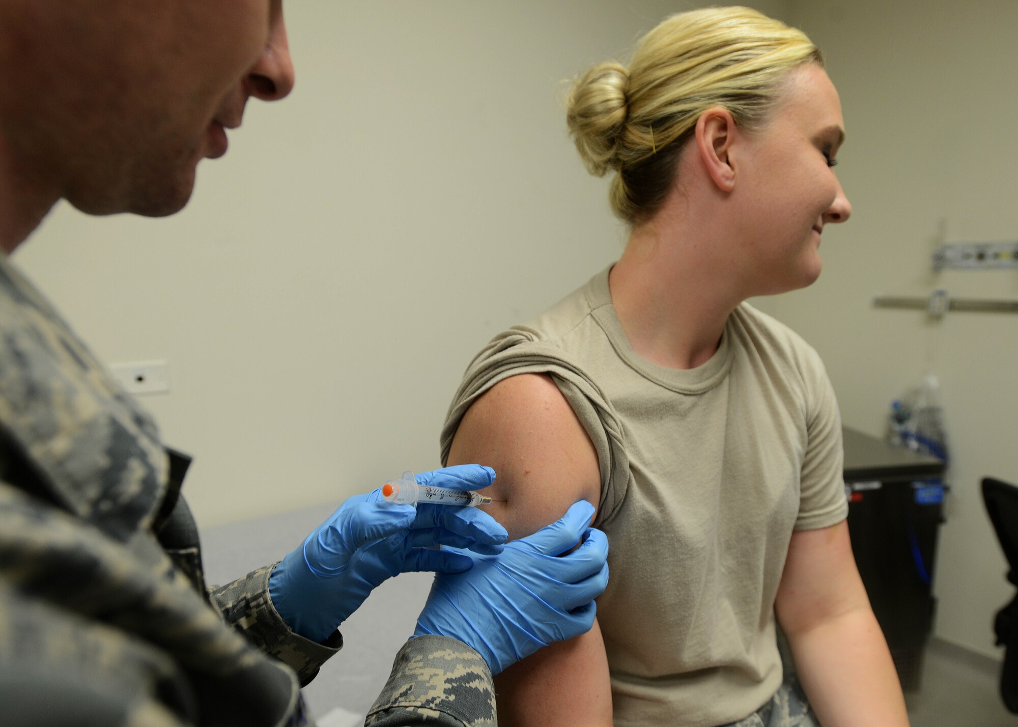 Staff Sgt. Justin Pribble vaccinates Airman 1st Class Micah Battistoni, Aug. 7, 2014, at Aviano Air Base, Italy. Common immunizations for teenagers and adults are seasonal flu vaccines, hepatitis A and B. Both Pribble and Battistoni are 31st Medical Operations Squadron medical technicians. (U.S. Air Force photo/Airman 1st Class Deana Heitzman)