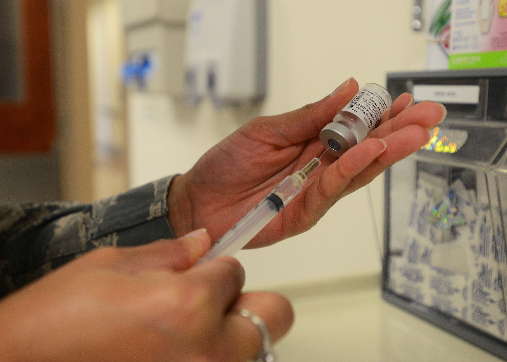 Staff Sgt. Bianca Raleigh, 31st Medical Operations Squadron NCO in charge of immunizations, prepares a polio vaccine, Aug. 7, 2014, at Aviano Air Base, Italy. The month of August is National Immunization Awareness Month, which encourages Team Aviano members to immunize against infectious diseases. (U.S. Air Force photo/Airman 1st Class Deana Heitzman)