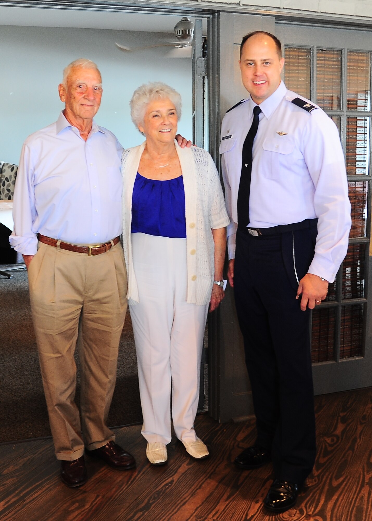(Ret.) Col. Carlyle "Smitty" Harris, his wife Louise, and Col. John Nichols, 14th Flying Training Wing Commander, pause for a photo at South restaurant in Tupelo, Mississippi Aug. 4. Harris was one of the original creators of the TAP code, which was used to communicate to the other prisoners in the solitary confinement. 
