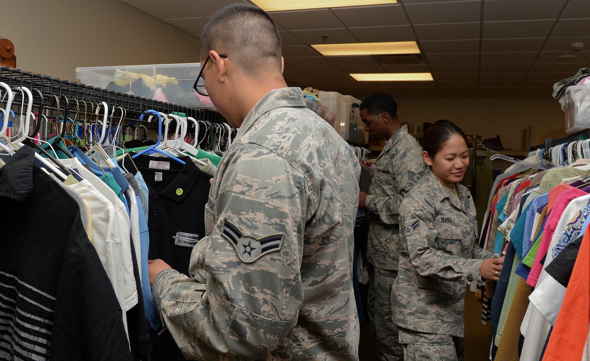 Airmen browse through clothes at the Airman’s Attic, Aug. 6, 2014, at McConnell Air Force Base, Kan. The attic provides Airmen E-5 and below with items that they or their families might need, all free of charge. The Airman’s Attic also takes donations every weekday from 10 to 2 p.m. (U.S. Air Force photo/Airman 1st Class Colby L. Hardin)