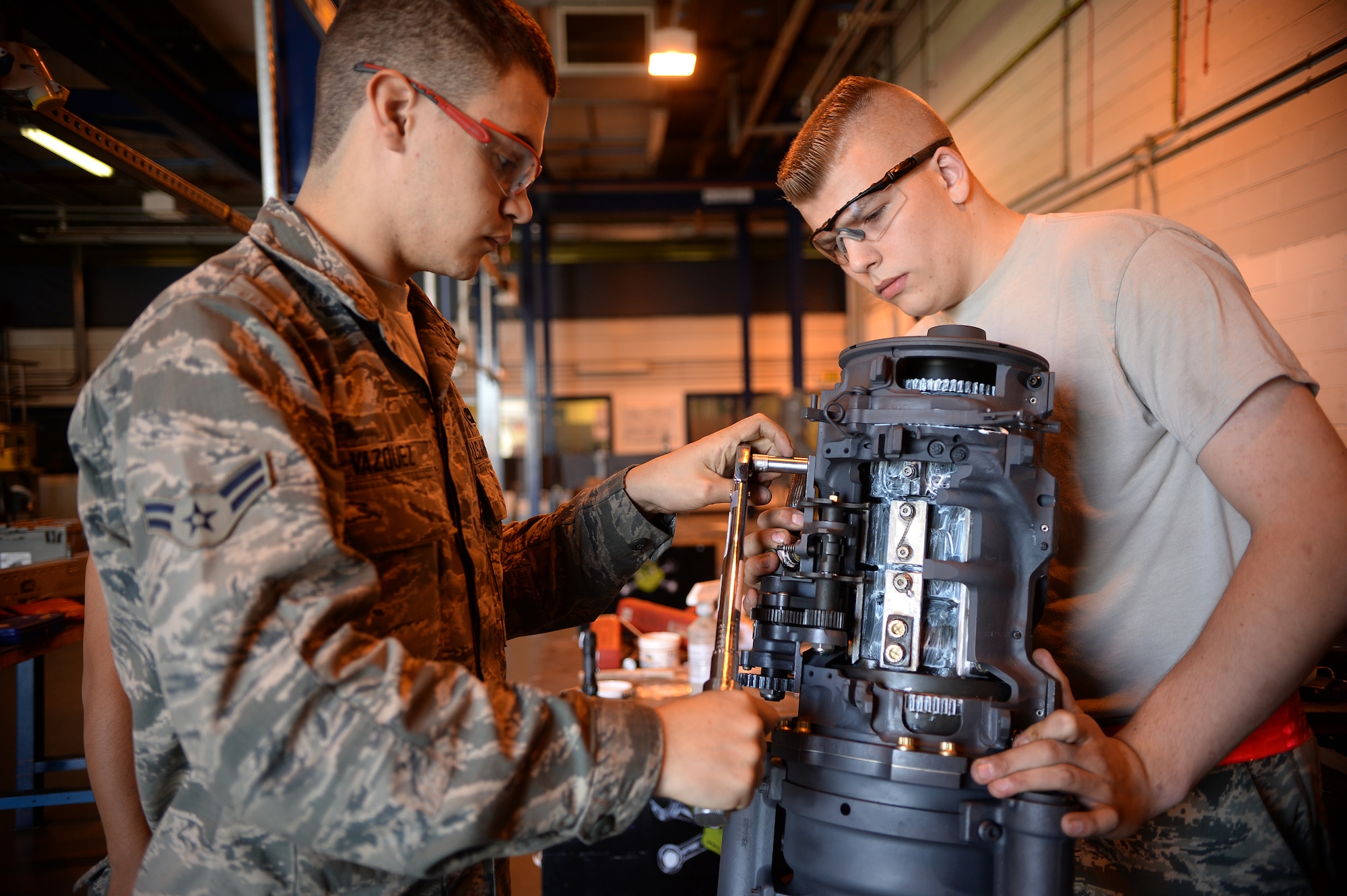 Airman 1st Class Jose Vazquez, 48th Munitions Squadron armament technician, and Airman 1st Class Cody Birnschein, 48th Equipment Maintenance Squadron aircraft metals technician, repair a fighter jet’s 20mm gatling rotor at Royal Air Force Lakenheath, England, Aug. 5, 2014. Different units go to metals technicians for their expertise to help repair equipment on a regular basis. (U.S. Air Force photo by Staff Sgt. Emerson Nuñez/Released)   