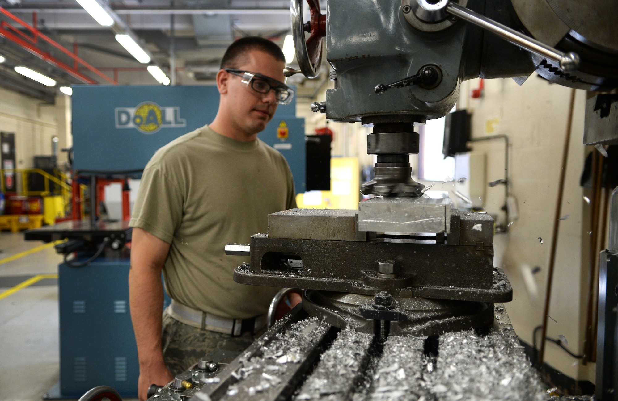 Staff Sgt. Michael Chavez-Detka, 48th Equipment Maintenance Squadron aircraft metals technician, uses a mill to level out a piece of metal at Royal Air Force Lakenheath, England, Aug. 5, 2014. Metals technicians combine on-aircraft work and in-shop fabrication in order to contribute to the 48th Fighter Wing’s mission by maintaining mulit-million dollar aircraft. (U.S. Air Force photo by Staff Sgt. Emerson Nuñez/Released) 