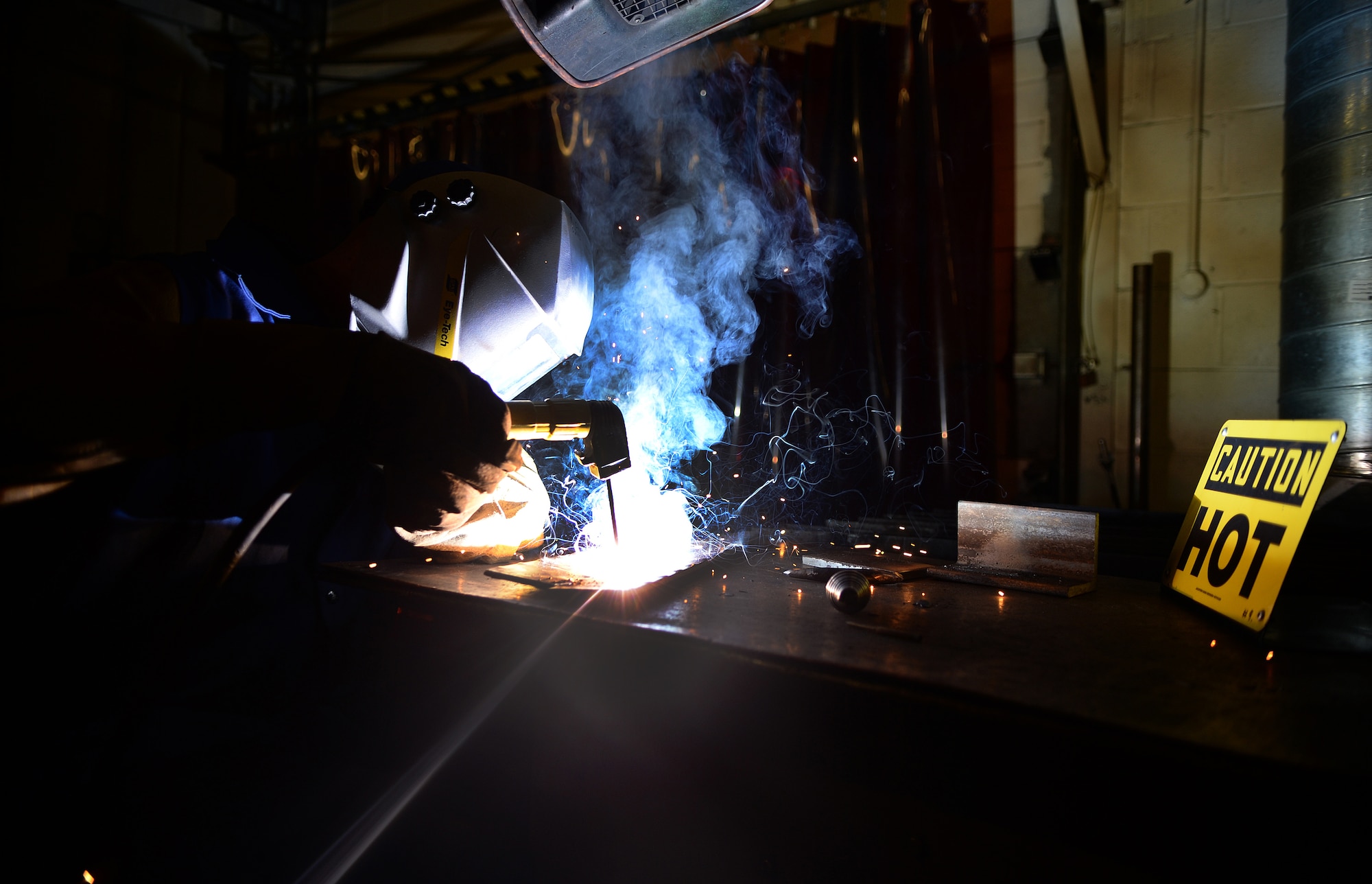 Senior Airman Robert Christensen, 48th Equipment Maintenance Squadron aircraft metals technician, welds two pieces of metal at Royal Air Force Lakenheath, England, Aug. 5, 2014. The top priority for the metals technology shop consists of creating tools uniquely sized for the 48th Fighter Wing’s aircraft. (U.S. Air Force photo by Staff Sgt. Emerson Nuñez/Released)