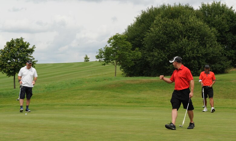 U.S. Air Force Chief Master Sgt. Thomas Keyser, 52nd Logistics Readiness Squadron chief enlisted manager and Eifel Mountain Golf Course team member, celebrates making an eagle putt during the Bitburgerland Ryder Cup tournament Aug. 3, 2014, at Bitburger Land Golf Course in Bitburg, Germany. Keyser won two-and-a-half points for the American team from Spangdahlem Air Base, Germany, during the two rounds of golf. (U.S. Air Force photo by Airman 1st Class Dylan Nuckolls/Released)