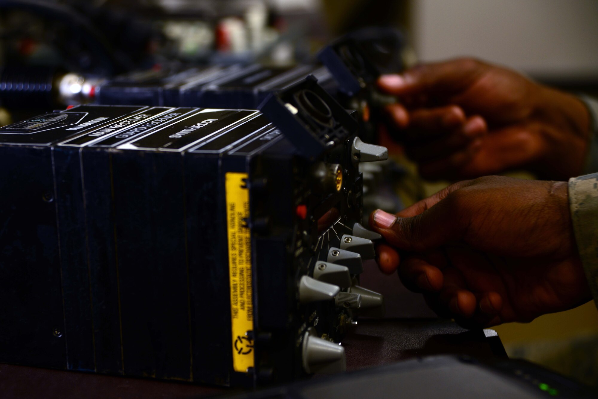 Senior Airmen Michael Hodges and Abshir Hagimohamed, 35th Maintenance Squadron avionics intermediate shop, test frequencies of a line-replacable unit at Misawa Air Base, Japan, July 25, 2014. Hodges and Hagimohamed work in the avionics backshop where they directly provide support to the mission of the 35th Fighter Wing. (U.S. Air Force photo/Senior Airman Derek VanHorn)