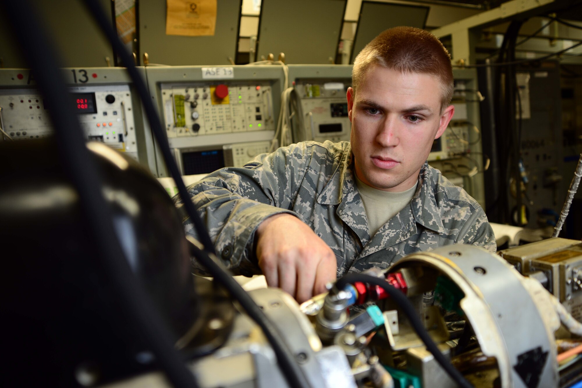 Airman 1st Class Jacob Delawder, 35th Maintenance Squadron electronic warfare team member, performs maintenance on an AN/ALQ-184 electronic countermeasure pod at Misawa Air Base, Japan, July 25, 2014. Delawder services electronic warfare pods that jam enemy radio detection and ranging capabilites for Misawa's Wild Weasel pilots. (U.S. Air Force photo/Senior Airman Derek VanHorn)