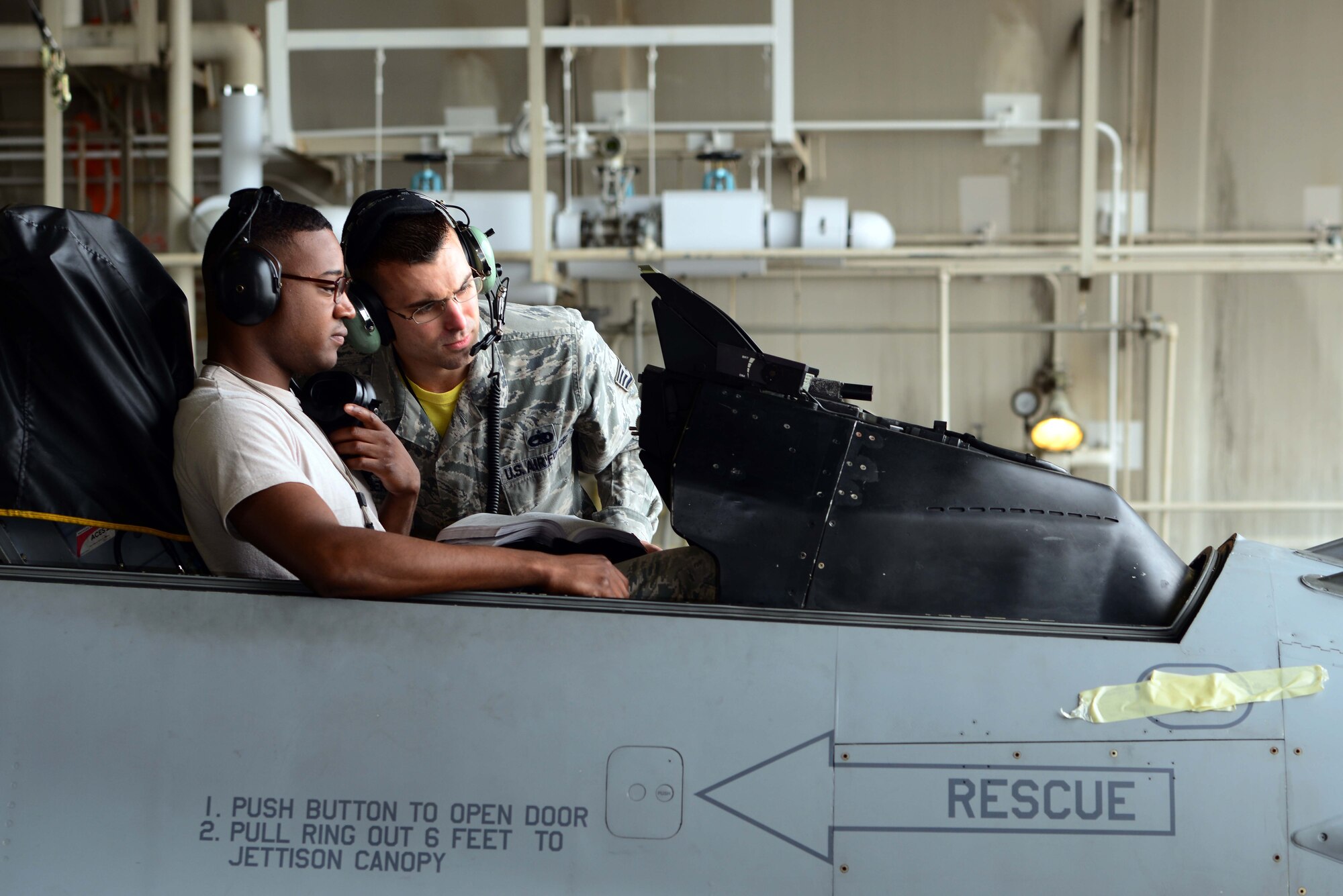 Senior Airman Carl Dunbar, left, and Staff Sgt. Andrew Mueller, 35th Aircraft Maintenance Squadron avionics technicians, perform follow-on maintenance on an F-16 Fighting Falcon at Misawa Air Base, Japan, July 11, 2014. Avionics Airmen work with nearly every flightline shop, as many systems within the aircraft depend on one another.(U.S. Air Force photo/Senior Airman Derek VanHorn)