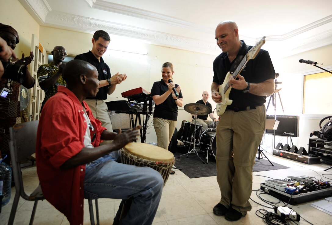 Recently, the USAFE Band popular music ensemble "Afterburner" performed in Dakar, Senegal as part of the USAFE-AFAFRICA African Partnership Flight.  Technical Sergeant Jason Cale jams with a student at a local Art school. (U.S. Air Force photo/ Staff Sgt. Ryan Crane)