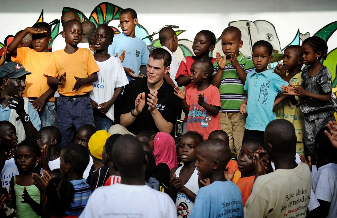 Recently, the USAFE Band popular music ensemble "Afterburner" performed in Dakar, Senegal as part of the USAFE-AFAFRICA African Partnership Flight.  Senior Airman Mike Mitchell (pictured above) bonds with children at the Empire des Enfants orphanage after a performance.  (U.S. Air Force photo/ Staff Sgt. Ryan Crane)