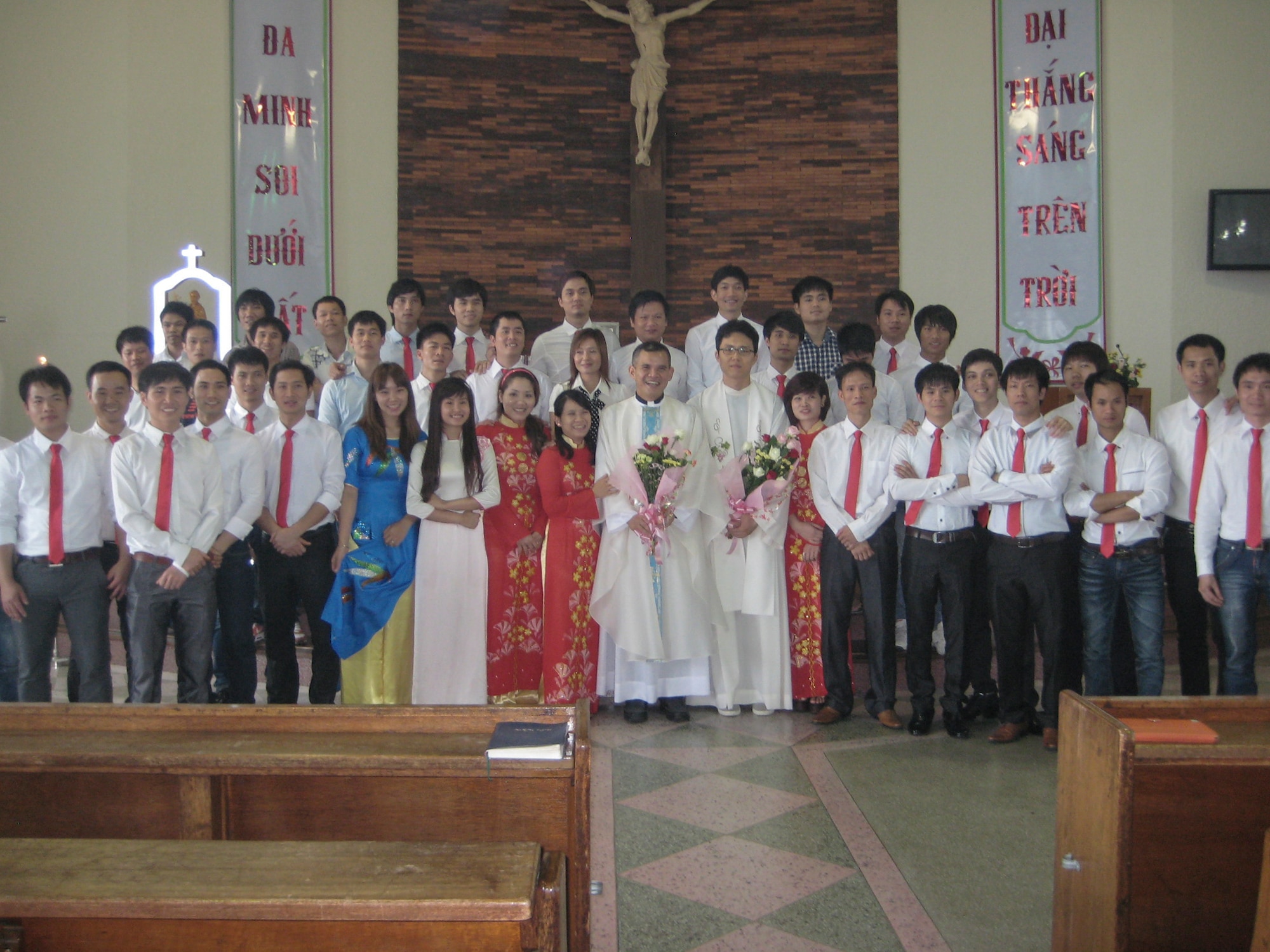 Chaplain (Capt.) Thienan Tran, 51st Fighter Wing chaplain, stands with his church members celebrating the feast day of Saint Dominic, their patron saint, at Cho-Rang Catholic Church in Busan, Republic of Korea Aug. 3, 2014. Tran spends his off-duty time providing Catholic Mass to communities of Vietnamese labor workers. (Courtesy photo)