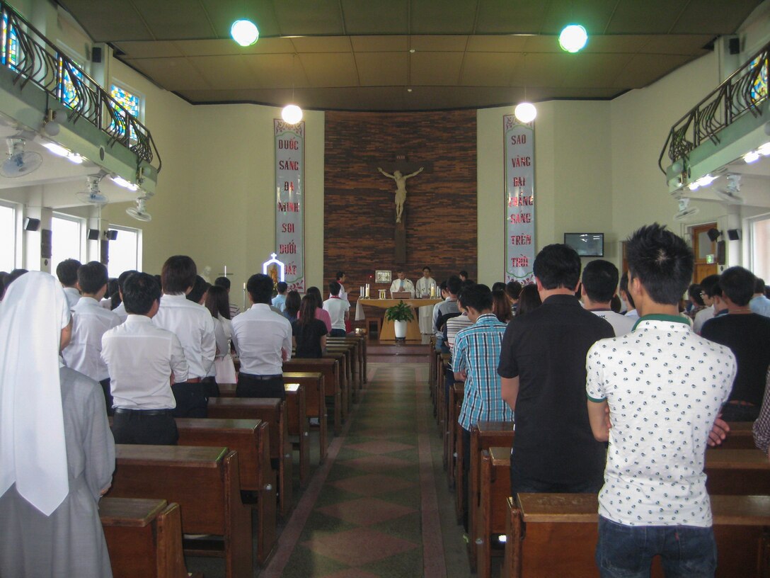 Chaplain (Capt.) Thienan Tran, 51st Fighter Wing chaplain, leads church members in prayer during a Catholic Mass at Cho-Rang Catholic Church in Busan, Republic of Korea, Aug. 3, 2014. Tran, a Catholic priest, spends his off-duty time providing Catholic Mass to communities of Vietnamese labor workers. (Courtesy photo)