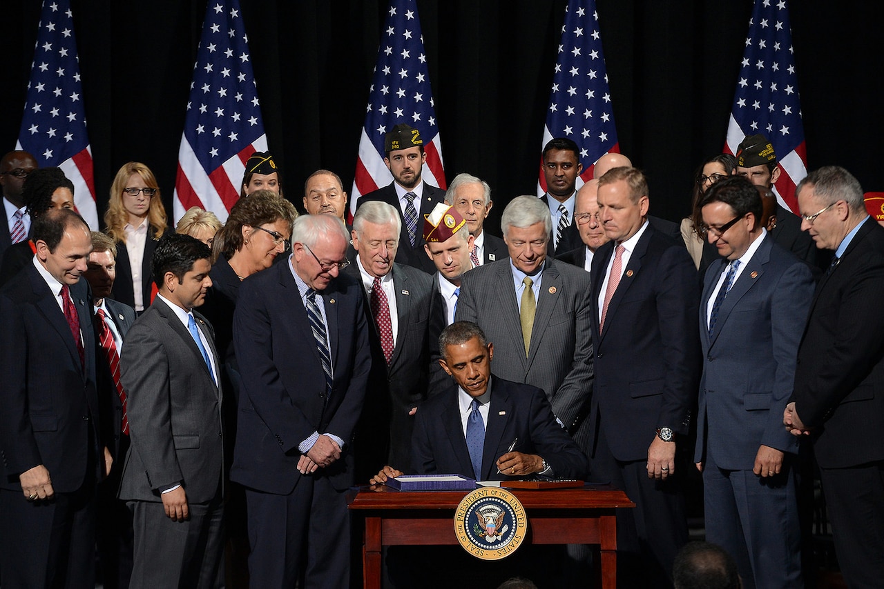 President Barack Obama signs the Veterans’ Access to Care through Choice, Accountability, and Transparency Act into law at Fort Belvoir, Va., Aug. 7, 2014. DoD photo by EJ Hersom
