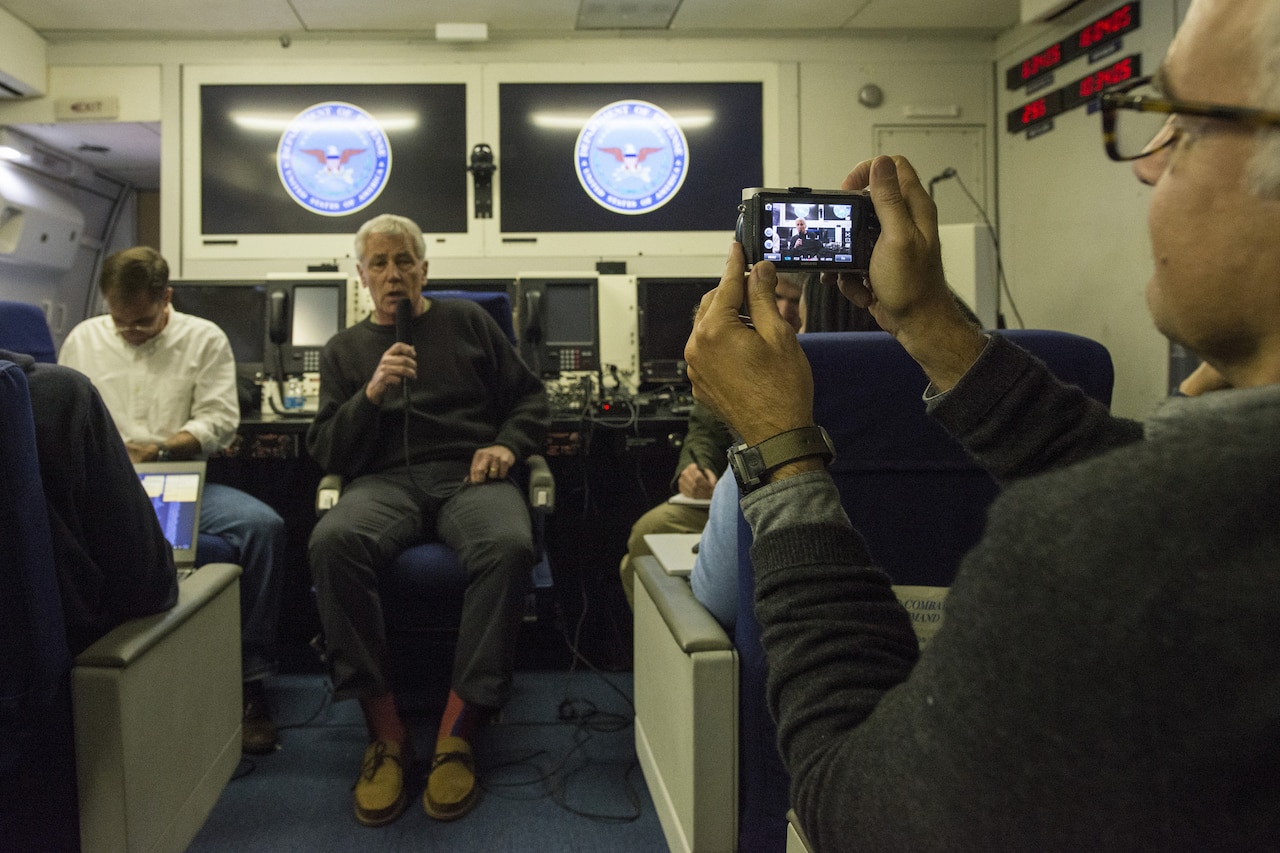 Defense Secretary Chuck Hagel briefs reporters on a military flight to New Delhi, Aug. 7, 2014. Hagel is traveling to India to meet new government leaders and foster defense trade agreements. DoD photo by Navy Petty Officer 2nd Class Sean Hurt
