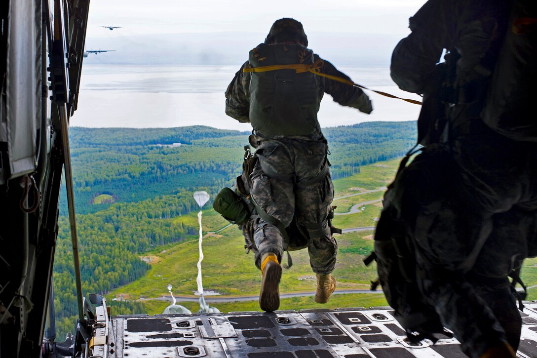 Paratroopers parachutes off the ramp of a C-130 Hercules aircraft during an off-site training sortie on Joint Base Elmendorf-Richardson, Alaska, Aug. 1, 2014.