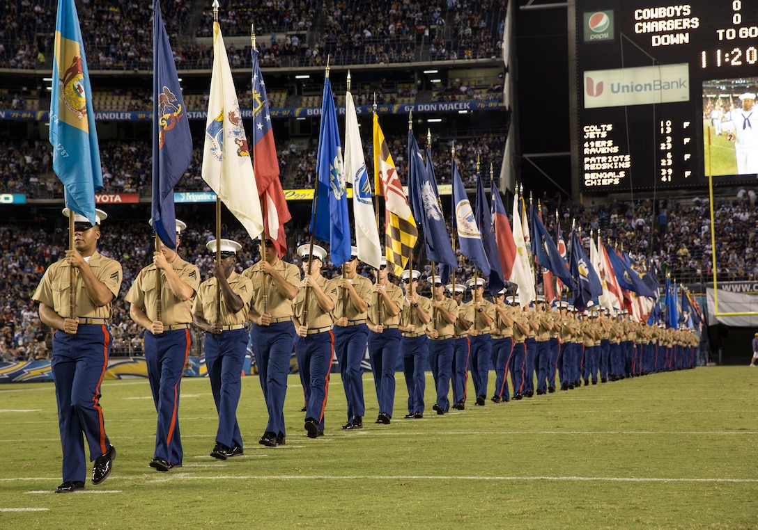 Marines with the 3rd Marine Aircraft Wing hold flags from all states during the 26th Annual Salute to the Military halftime show at Qualcomm Stadium, San Diego, Aug. 7. The Chargers invited Marines, Sailors and Soldiers onto the field before the game and during halftime.