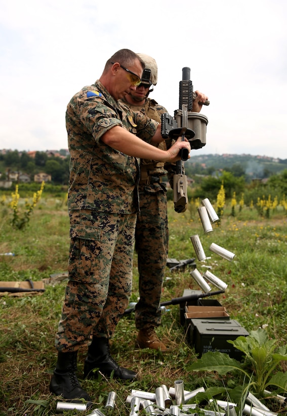 A soldier from the Armed Forces of Bosnia and Herzegovina unloads the M32 grenade launcher during a non lethal systems familiarization exercise in Sarajevo, Bosnia and Herzegovina, July 23. The M32 grande launcher holds six rounds of 40mm ammunition. 